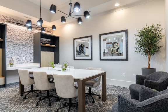 A conference room with a white table, chairs, and framed pictures on the wall.at The One at Millington, Millington, 38053