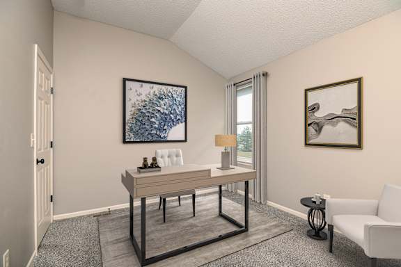 A room with a table, chairs, and two pieces of artwork on the wall.