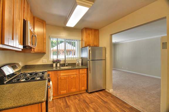 A kitchen with white appliances and cabinets.