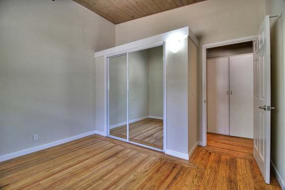 a room with a door open to a bathroom and a closet