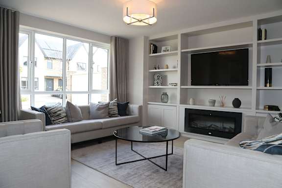 a living room with a couch and a table and a television