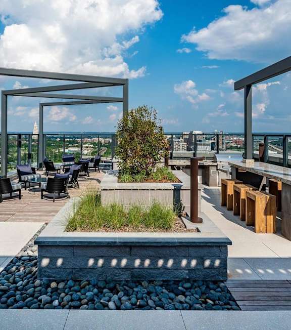 A patio with a table and chairs overlooking a cityscape.