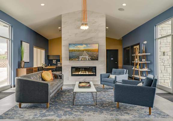 clubhouse with blue furniture and a fireplace