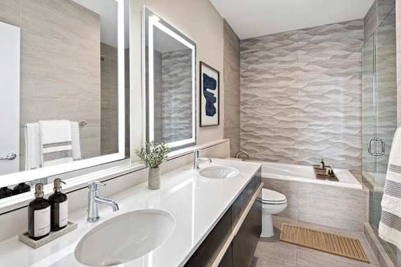 A bathroom with a white sink and a mirror above it.