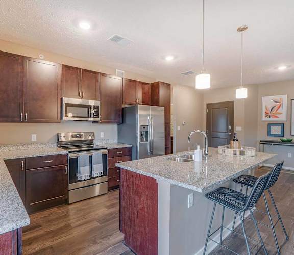 a kitchen with granite counter tops and stainless steel appliances