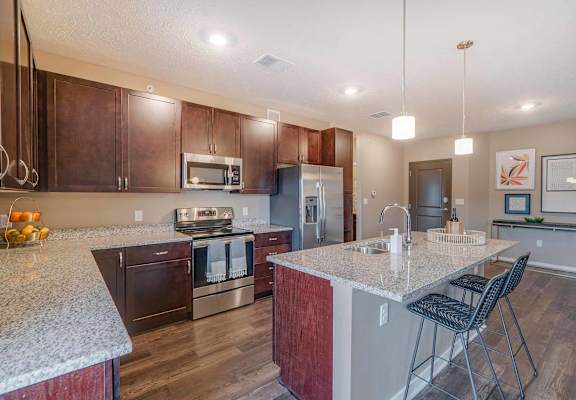 a kitchen with granite counter tops and stainless steel appliances