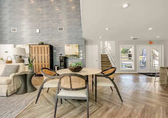 A modern dining area with a wooden table and chairs.