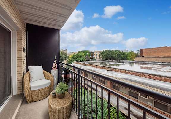 a balcony with a chair and a table