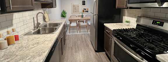 A kitchen with stainless steel appliances and marble counter tops at Briarlane Apartments in Grand Rapids, Michigan