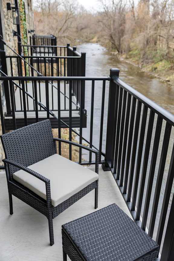 A group of people are standing on a balcony holding sparklers. at The Dean at Creekview Apartments, Newark, Delaware