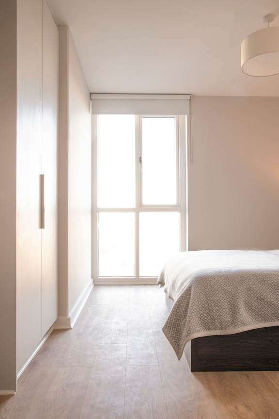 a bedroom with a bed and a window