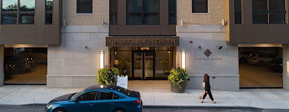 a woman walks past the entrance to the ninfenner mortimer building