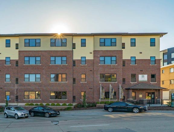 The Helen apartment building exterior with street parking