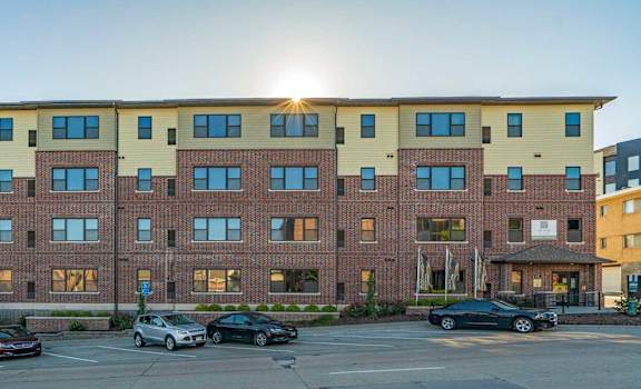 The Helen apartment building exterior with street parking