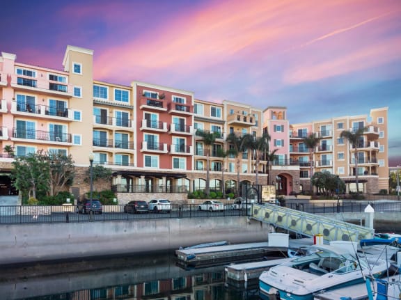 A row of colorful buildings with boats docked in front. at Marina Harbor, California, 90292