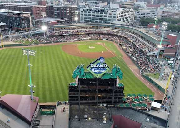 A baseball stadium is filled with fans watching a game.