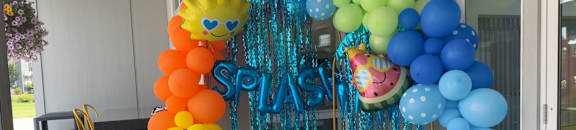 A balloon arch decorated with blue and orange balloons.