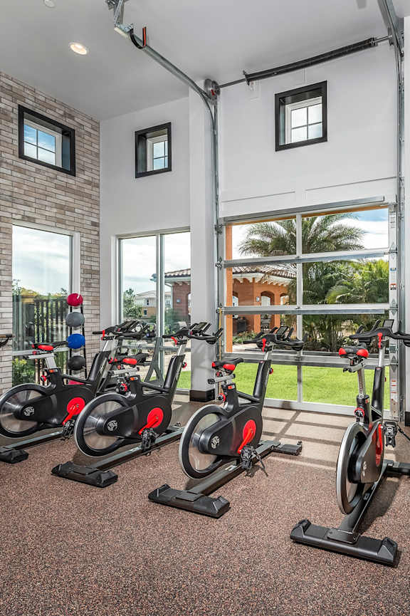 a fitness center with cardio equipment and weights in a gym
