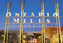 A sign that says Ontario Milis Fashion District.