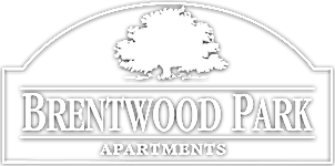 Property entrance sign with tree silhouette at Brentwood Park Apartments, Nebraska