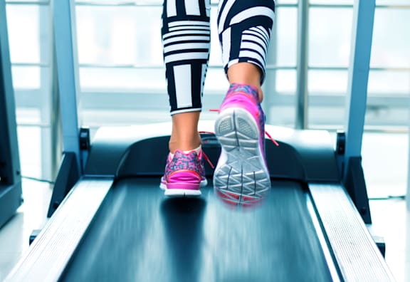 a person running on a treadmill with text get fit