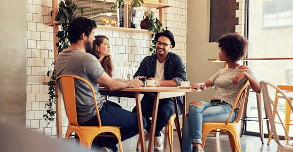 a group of people sitting at a table in a restaurant