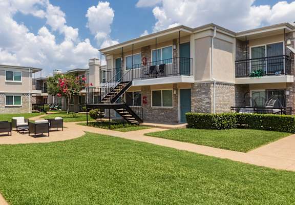 This is a photo of building exteriors and the grounds at The Summit at Midtown Apartments in Dallas, TX.