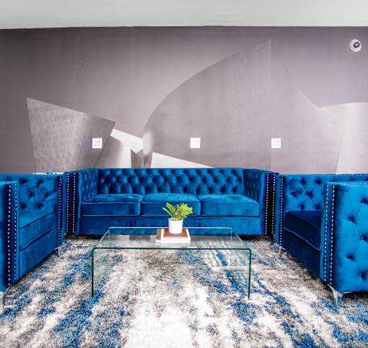 Clubroom with seating at The Preston Miracle Mile Apartments, Los Angeles, California