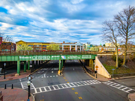 a bridge over a city street with a building in the background