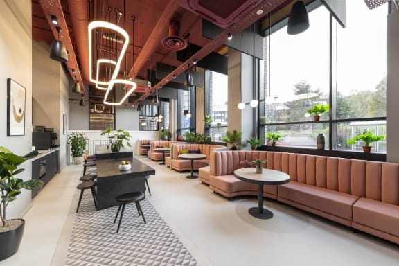 a lobby with couches tables and chairs and a large window