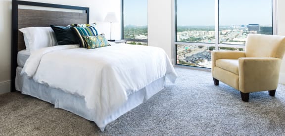 furnished bedroom with floor to ceiling windows