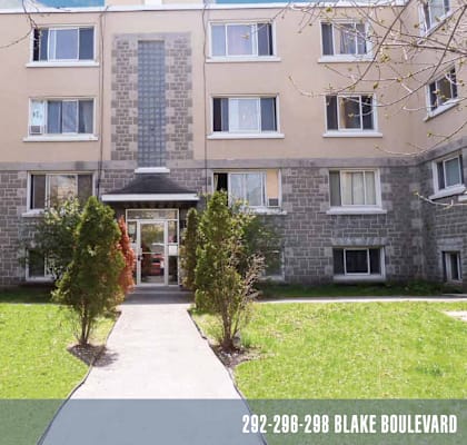 an apartment building with a walkway leading to the front door