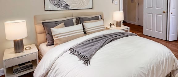 a bedroom with a large bed and a ceiling fan