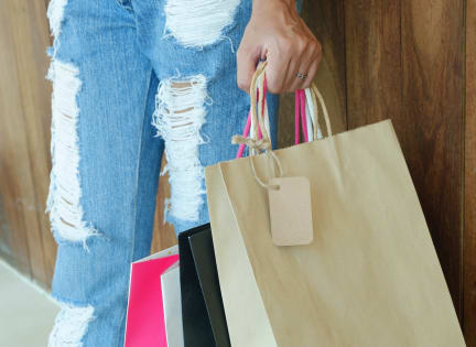 a woman holding a paper bag with shopping bags at 44 Washington, Kansas City, MO