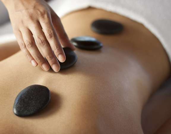 rear view of a woman receiving acupuncture stones on her backat VALE Lake WylieApartments, Clover , SC 29710