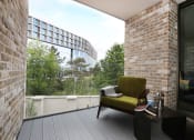Thumbnail 2 of 7 - a terrace with a chair and a table and a window