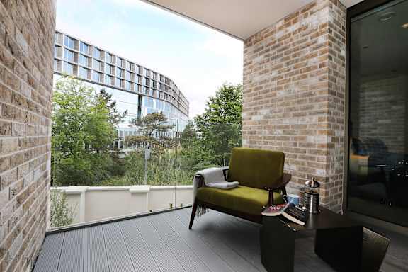 a terrace with a chair and a table and a window