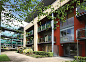 Thumbnail 7 of 9 - a row of apartments with balconies and a courtyard