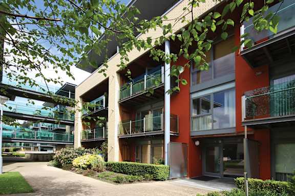 a row of apartments with balconies and a courtyard