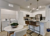 Thumbnail 25 of 28 - an open kitchen and dining area with a marble counter top and stainless steel appliances at Estraya Boerne, Texas, 78006