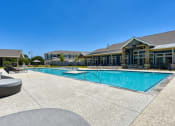 Thumbnail 2 of 28 - a swimming pool with a building in the background at Estraya Boerne, Boerne