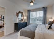 Thumbnail 28 of 28 - a bedroom with a large bed and a ceiling fan at Estraya Boerne, Texas