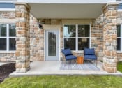 Thumbnail 14 of 28 - a front porch of a house with two chairs and a table