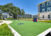 Thumbnail 7 of 28 - an image of a playground in front of an apartment building at Estraya Boerne, Boerne