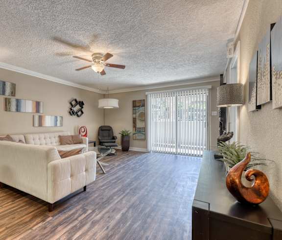 a living room with a couch and a ceiling fan