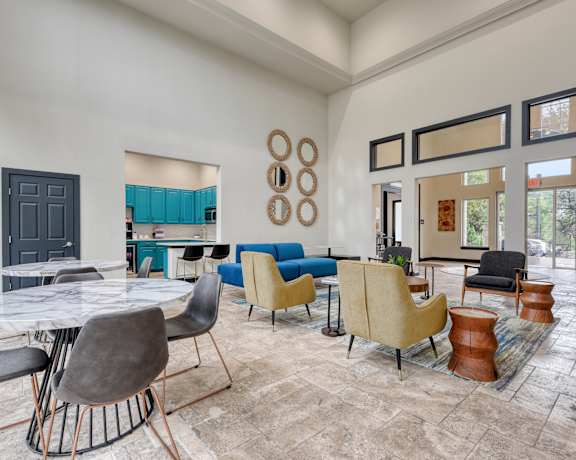 the reserve at bucklin hill clubhouse with tables and chairs and a kitchen in the background