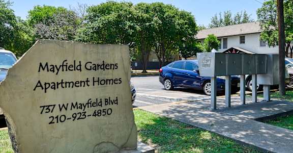 a sign apartment homes in front of a parking lot