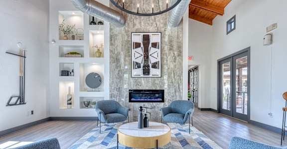 A living room with a fireplace and a chandelier.
