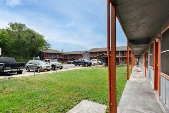 a view of a building with cars parked in a parking lot at The Crossings at Montrose Apartments, San Antonio