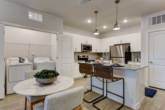 an open kitchen and dining area with a marble counter top and stainless steel appliances at Estraya Boerne, Texas, 78006
